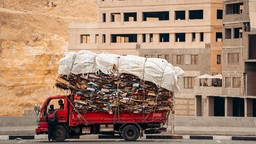 Truck carrying a huge load of cardboard.