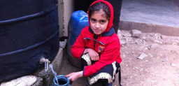 A girl in Pakistan collects rainwater for washing (Photo: Fawad Khan)