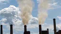 Five chimneys. Two of them releasing smoke. 