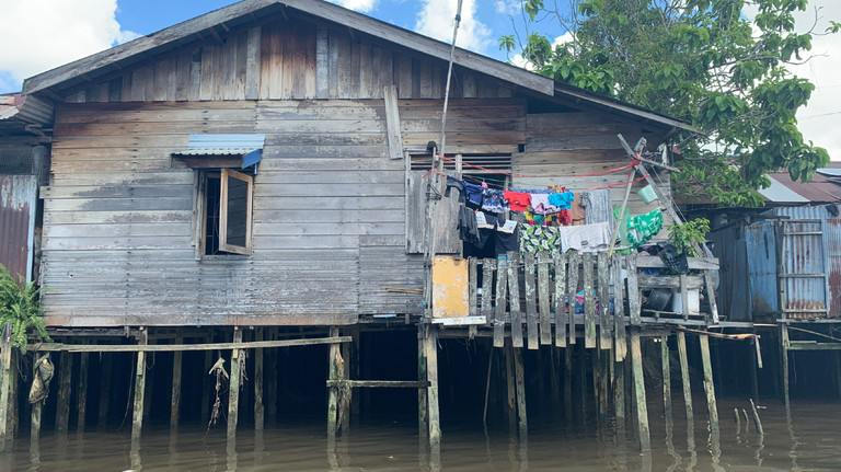A house on stilts above a body of water.