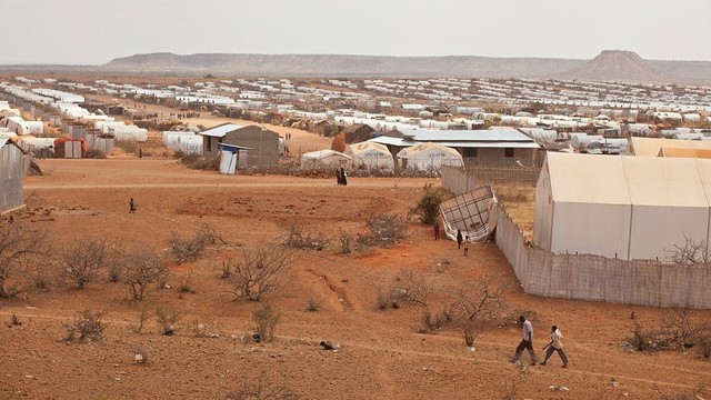 A view of a large camp in a desert landscape.