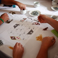 People playing a board game.	